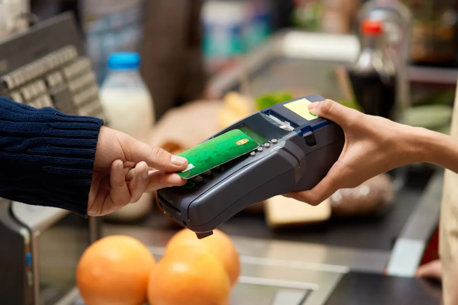 making a contactless payment at a point-of-sale (POS) terminal in a store. black people